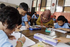 Guru (tengah) berinteraksi pada kegiatan belajar mengajar menggunakan metode kurikulum 2013 di SD Negeri 1, Daan Mogot, Tangerang, Banten, Selasa (2/9).